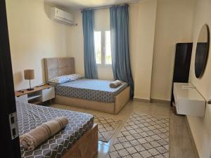 a small room with two beds and a window at Private Villa Sea View 5BR in Ain Sokhna +46 photos