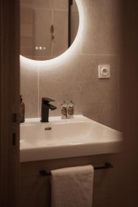 a bathroom with a sink and a mirror at Sezam Appart-Hotel Rennes in Rennes +49 photos