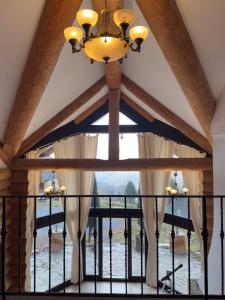 a ceiling with a chandelier and a window at Mi Chalet - Poiana Izvoarelor in Vatra Dornei