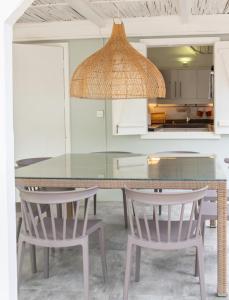 Villa Coconut Oasis في Bain Boeuf: غرفة طعام مع طاولة وكرسيين +23 صورة