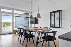 a dining room with a wooden table and black chairs at 784-Thisted-Havstokken-30-A in Thisted +20 photos
