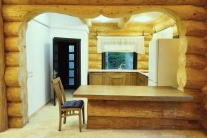 a kitchen with a wooden table and a refrigerator at Mi Chalet - Poiana Izvoarelor in Vatra Dornei +17 photos