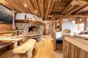 a living room with a stone fireplace at Ferienhütte Alpenherz in Alpbach