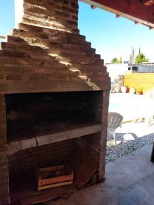 an outdoor brick fireplace with a pizza box at Cabañas los materos 2 in Córdoba
