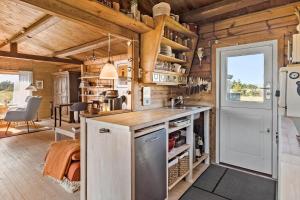 a kitchen with wooden walls and a refrigerator and a counter at 309-Bedsted-Thy-Redningsvej-9 in Bedsted Thy +11 photos