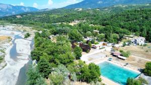 an aerial view of a resort with a swimming pool and a river at Camping Tikayan La Célestine - Maeva in Beynes