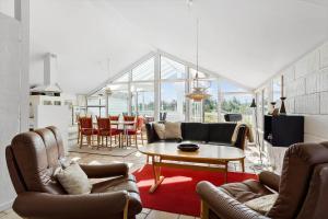 a living room with chairs and a table and a kitchen at 542-Thisted-Kuttervej-11 in Thisted