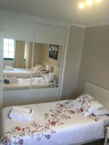 a bedroom with two beds and a large mirror at Paradise Club L28 & L29 in Puerto del Carmen +30 photos