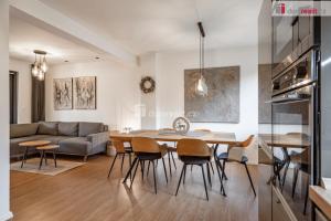 a kitchen and living room with a table and chairs at Apartmány Fun & Relax Dolní Morava in Dolní Morava