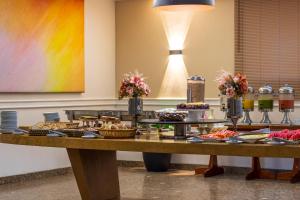 a buffet of food on a table in a room at Braston Augusta Hotel by Castelo Itaipava in Sao Paulo +25 photos