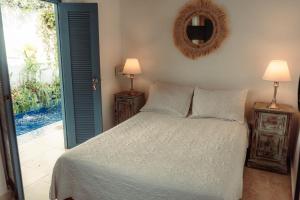 a bedroom with a bed and a mirror on the wall at Casa Heredia Boutique in Cartagena de Indias