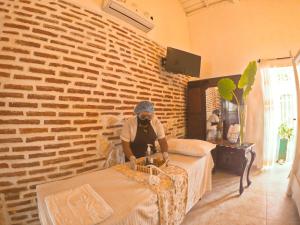 a person wearing a mask in a room with two beds at Casa Heredia Boutique in Cartagena de Indias