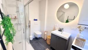 a bathroom with a shower and a sink and a mirror at M8 ParkSide Studio One in Graz +4 photos