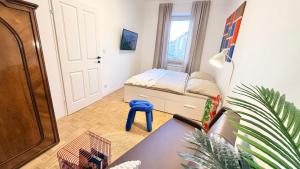 a living room with a bed and a desk at M8 ParkSide Studio One in Graz
