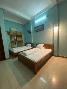 Postel nebo postele na pokoji v ubytování Kim Tinh Hostel