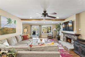 a living room with a couch and a fireplace at Bright 3BR Beach Condo Near Casino and Ole Hanson in San Clemente