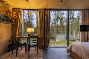 a bedroom with a desk and a bed and a window at The Illusion Hideaway in New Plymouth