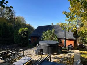 a backyard with a hot tub and a house at Chata pod Prašivou in Vyšní Lhoty