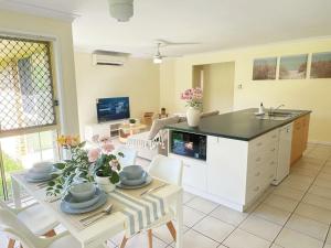 a kitchen and living room with a table and a sink at Riverview Modern Haven in Riverview +20 photos