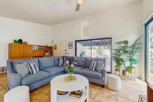a living room with a blue couch and a table at Jewel of the Desert 259-342 in La Quinta