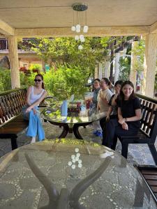 a group of people sitting around a glass table at Cat Tien Vista in Tân Phú