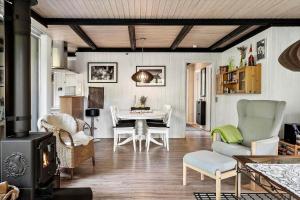 a living room with a table and chairs and a stove at 1344-Vestervig-Hedevej-43 in Vestervig +12 photos