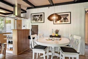 a dining room with a white table and chairs at 1344-Vestervig-Hedevej-43 in Vestervig