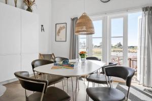 a dining room with a white table and chairs at 1346-Vestervig-Havnevej-1-lejl-15 in Vestervig