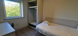a small room with a bed and a window at New Refurbed 4BDR on Dock Road Near City Centre in Limerick