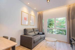 a living room with a couch and a table at Stancia Benimaclet - Studio 9 in Valencia
