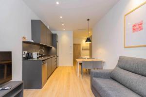 a kitchen and living room with a couch and a table at Stancia Benimaclet - Studio 9 in Valencia