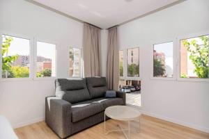 a living room with a couch and a table at Stancia Benimaclet - Studio 7 in Valencia