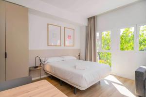 a bedroom with a large bed and a window at Stancia Benimaclet - Studio 7 in Valencia