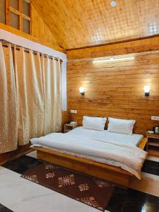 a bedroom with a bed with a wooden wall at Mistymountaincottage in Shimla