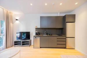 a kitchen with stainless steel appliances in a room at Stancia Benimaclet - Studio 1 in Valencia
