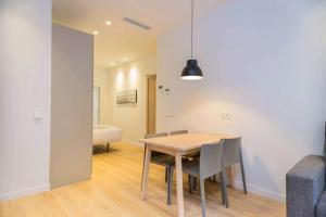 a dining room with a wooden table and chairs at Stancia Benimaclet - Studio 1 in Valencia