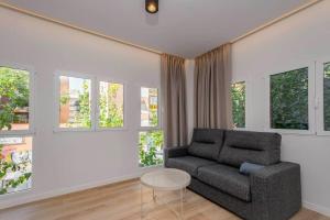 a living room with a couch and a table at Stancia Benimaclet - Studio 11 in Valencia