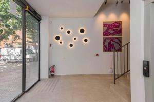 a hallway with a white wall with a large window at Stancia Benimaclet - Studio 11 in Valencia +10 photos