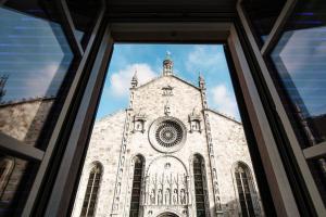 a view of a church through a window at Vitrum - Como Luxury Suites in Como