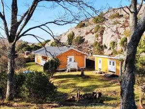 Cottage with Natural Plot and Sauna on Mjörn SE09134 في Dyvik: منزل صغير في حقل مع جبل +23 صورة