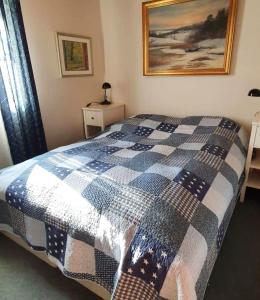 Cottage with Natural Plot and Sauna on Mjörn SE09134 في Dyvik: غرفة نوم مع سرير وبطانية مقلية