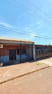 a brick building with a fence in front of it at La Reina in Eldorado