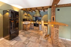 a kitchen with a black refrigerator and a counter at Eden Escapes in Olsberg