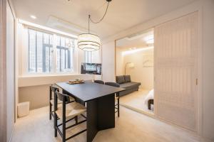 a dining room and living room with a table and chairs at 율 한옥 호텔 in Samgong +83 photos