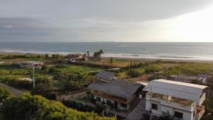 an aerial view of a house and the beach at Mambo Ecohostal in San Lorenzo