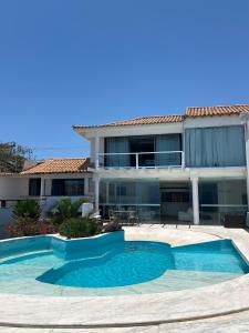 ein Swimmingpool vor einem Haus in der Unterkunft Villa Romana Búzios in Búzios