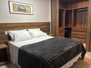 En eller flere senge i et værelse på Flats no Mercure Belém Boulevard