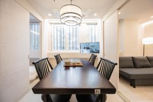 a dining room with a table and chairs and a couch at 율 한옥 호텔 in Samgong