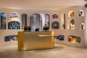 a lobby with a reception desk with stained glass windows at Hyatt Centric Reims in Reims