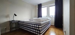 a bed sitting in a room with a window at Modern villa with sea view in Svanesund SE09101 in Svanesund